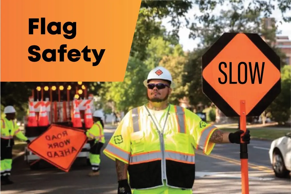 Worker receiving flag safety training for construction and traffic control duties